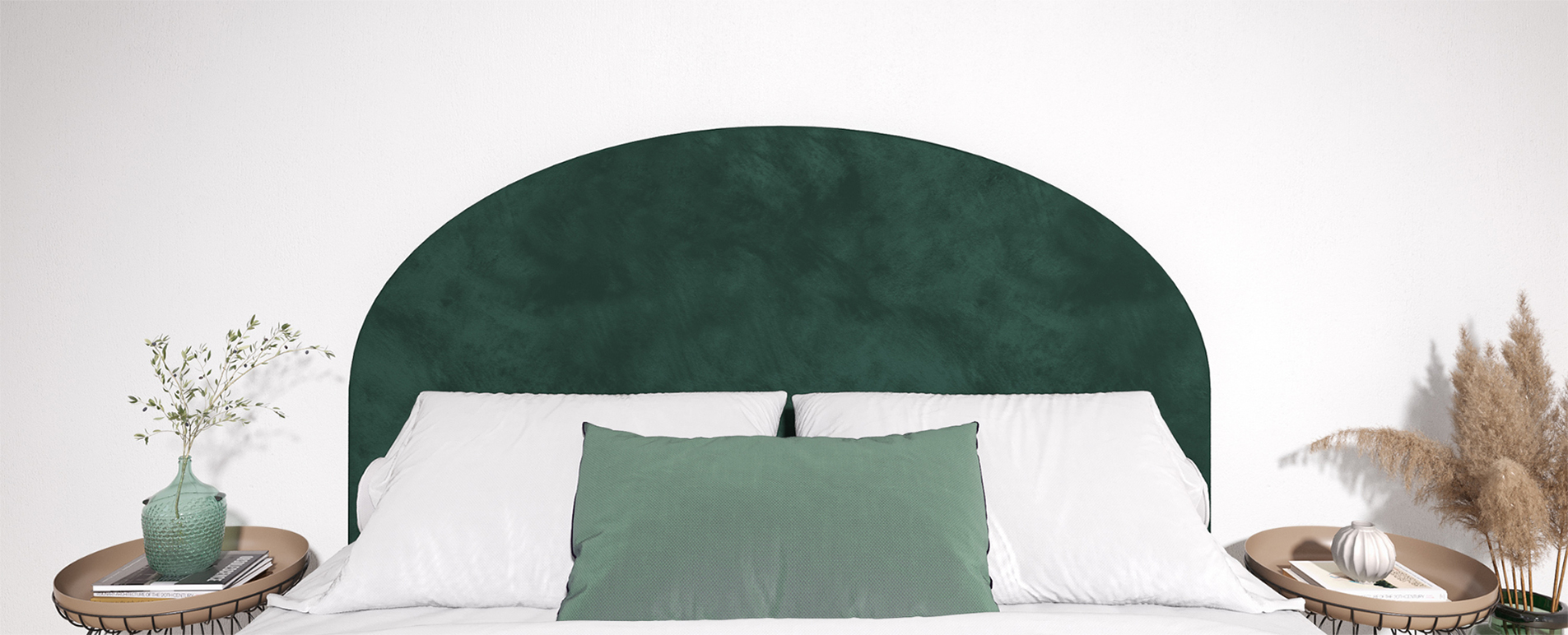Rounded Emerald headboard behind a bed